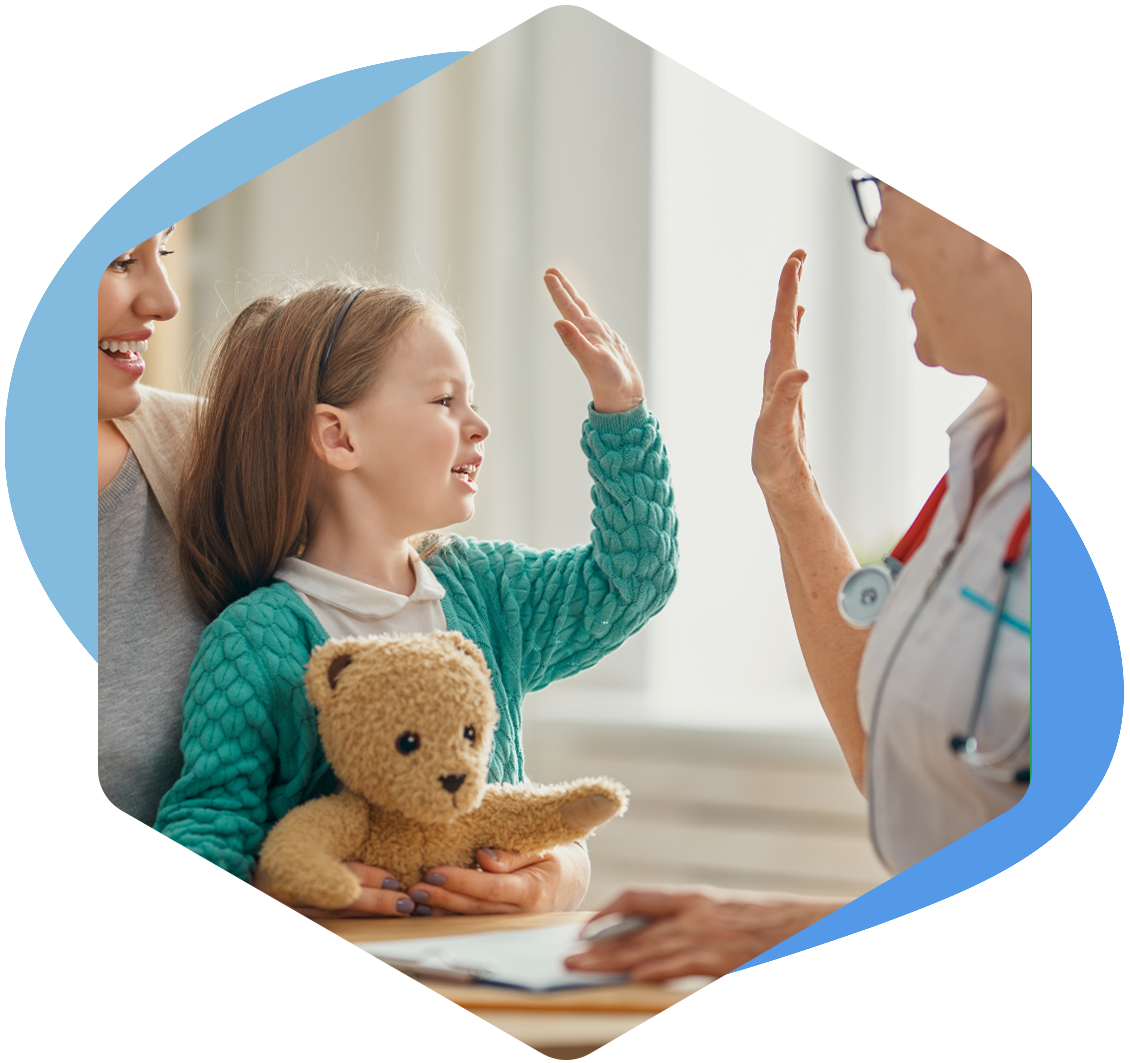 child high-fiving a medical professional wearing a blue plastic glove.