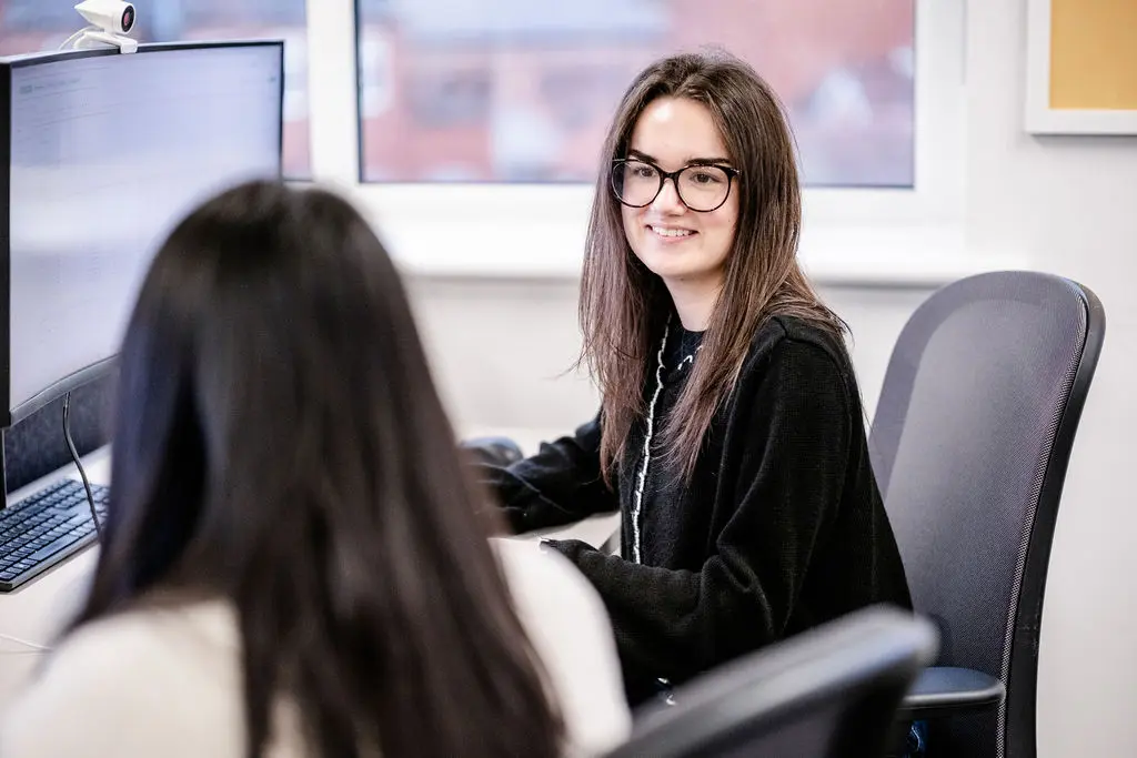 IBM Experts collaborating at side of desk.
