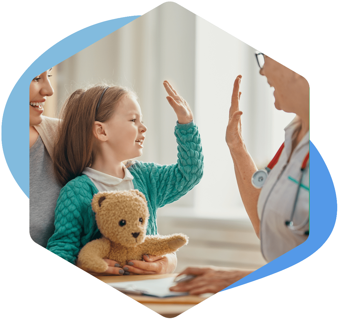 child high-fiving a medical professional wearing a blue plastic glove.
