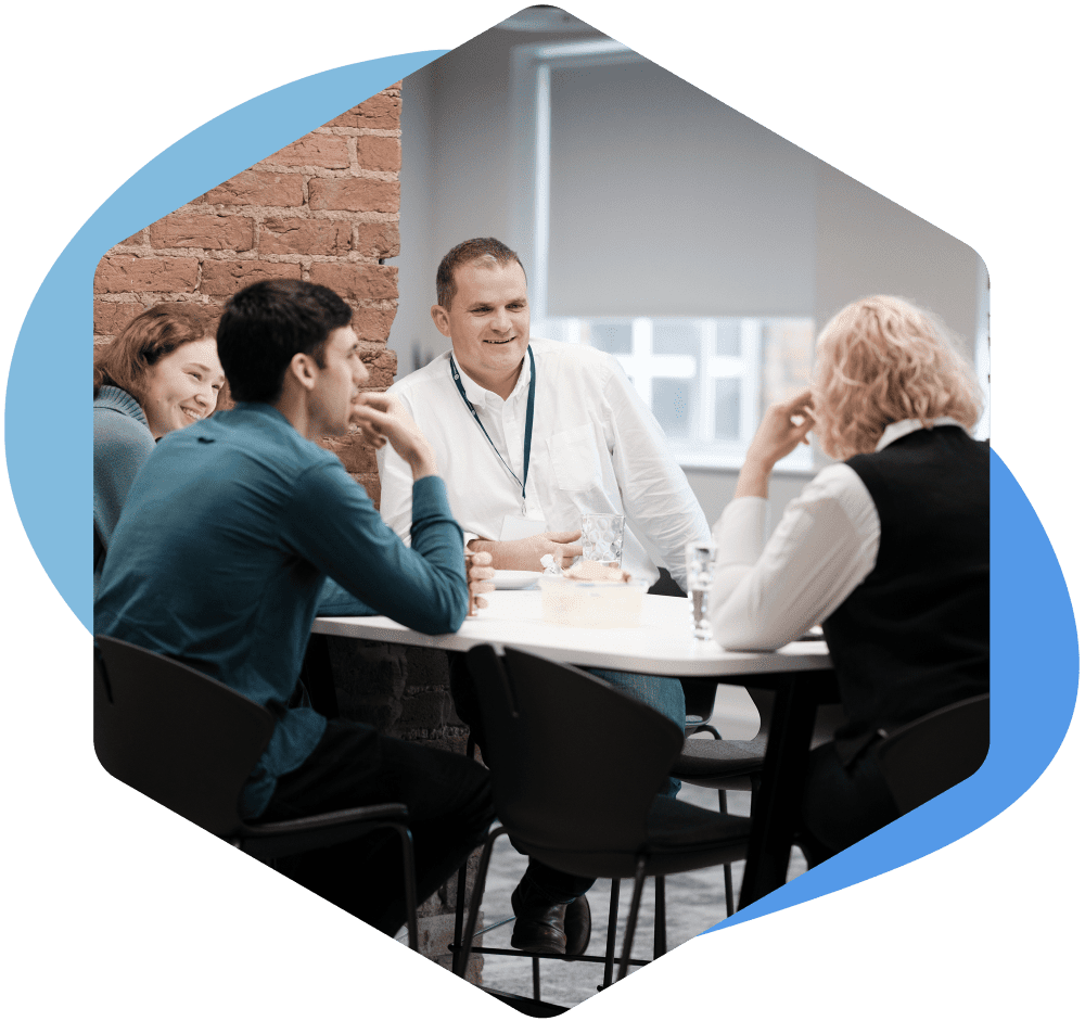 Our managing director, Giles, sat with a group of consultants, laughing