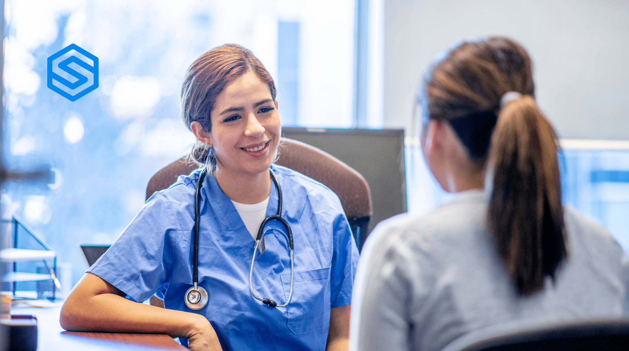 NHS doctor talking to a patient